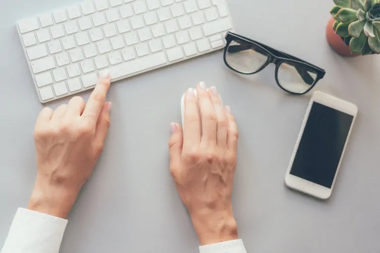 customer hands poised on keyboard and mouse ready to convert