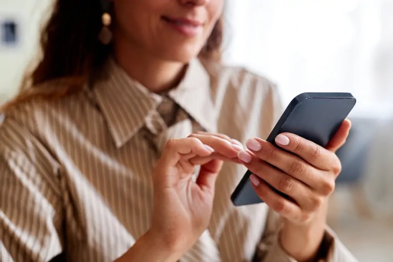 customer smiling poised to convert on mobile device